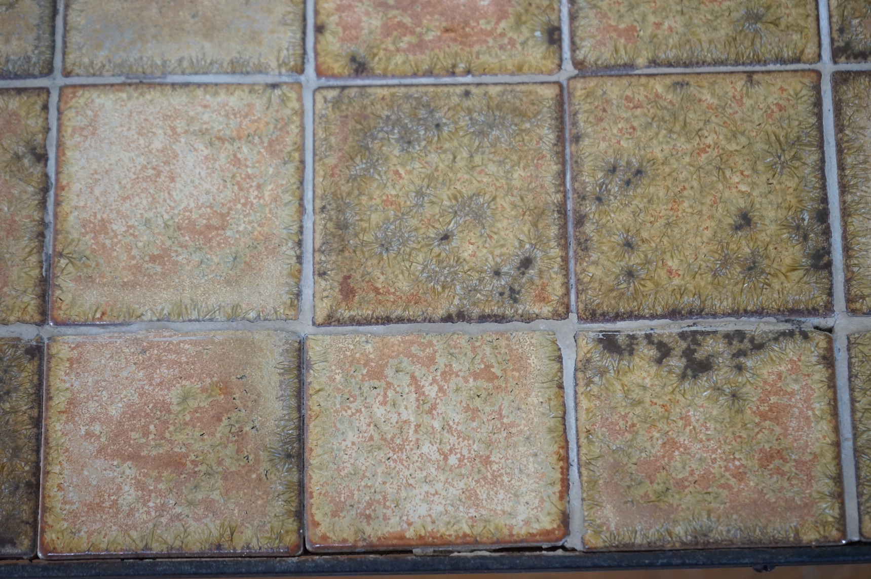 Manner of Roger Capron (French), an Iron and ceramic tile top table, 76cm wide. Condition - fair